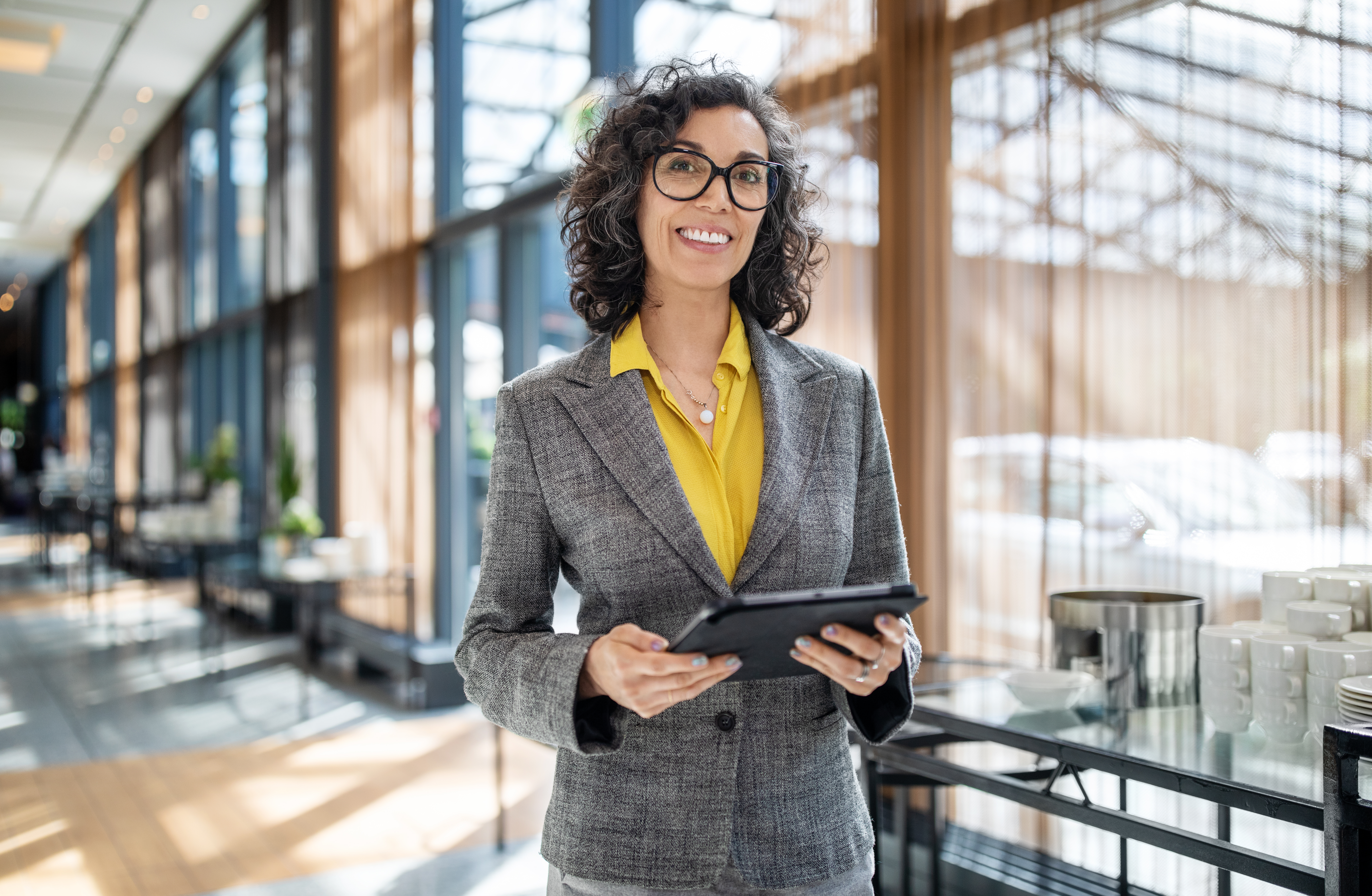 Senior businesswoman in corridor with digital tablet